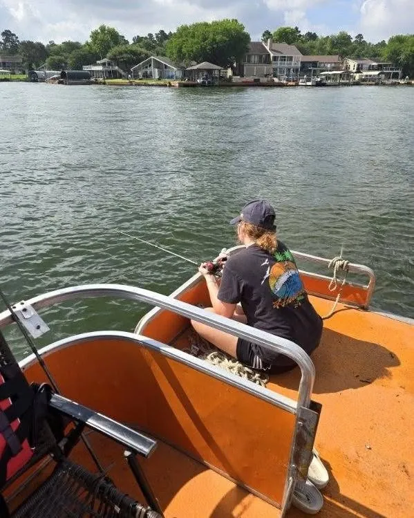 Young anglers seated on a fishing boat on Lake Conroe. Lake Conroe Fishing Guide - Billy Mills
