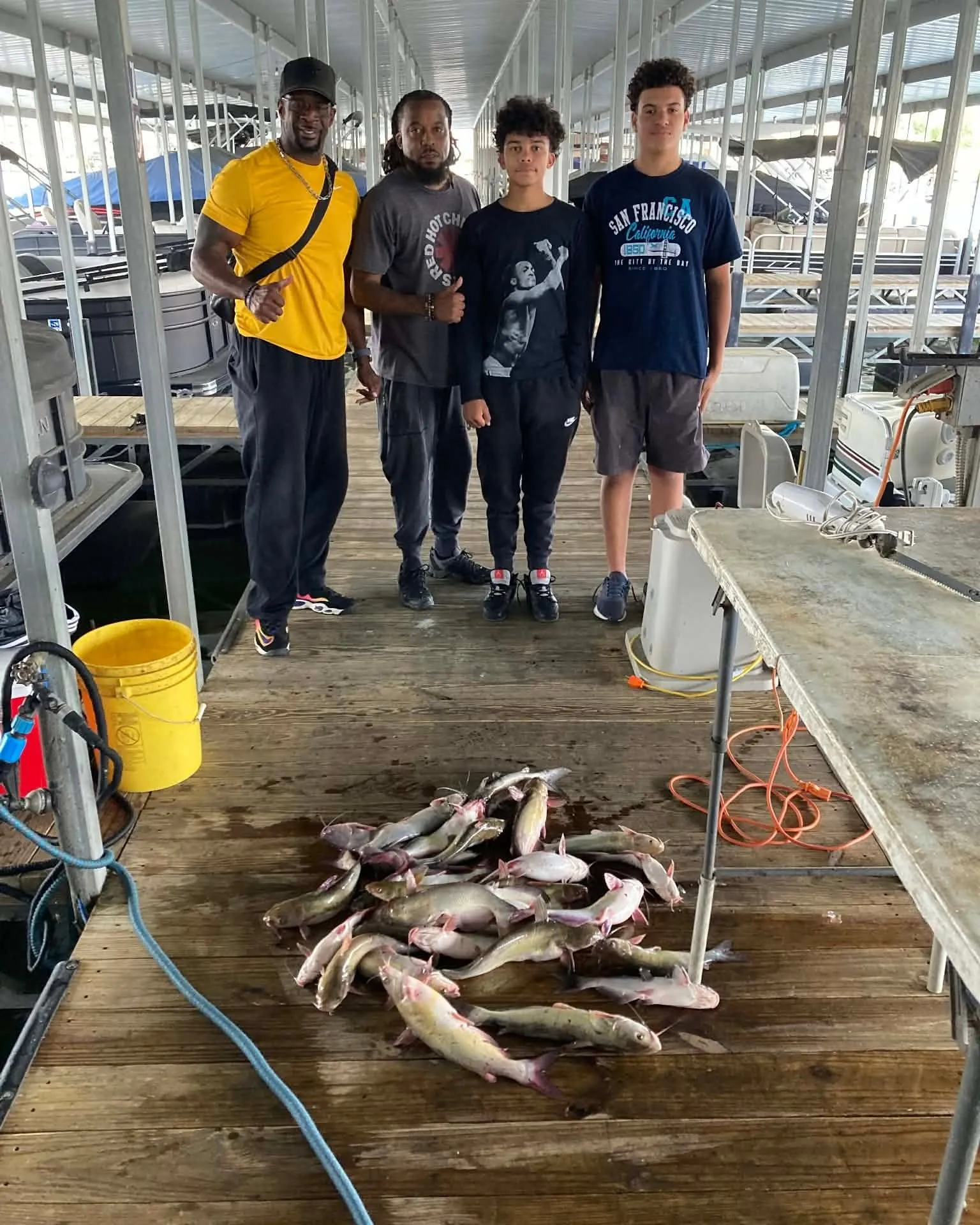 Guests standing on a dock with fish from a Lake Conroe trip. Lake Conroe Fishing Guide - Billy Mills