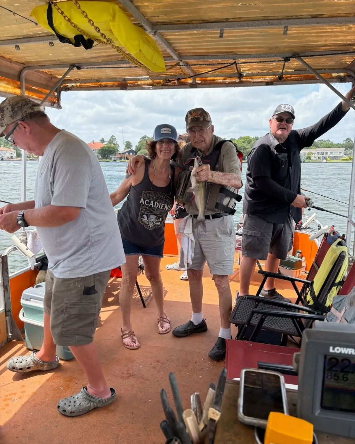 Guests gathered for a fishing trip on a covered Lake Conroe boat. Lake Conroe Fishing Guide - Billy Mills