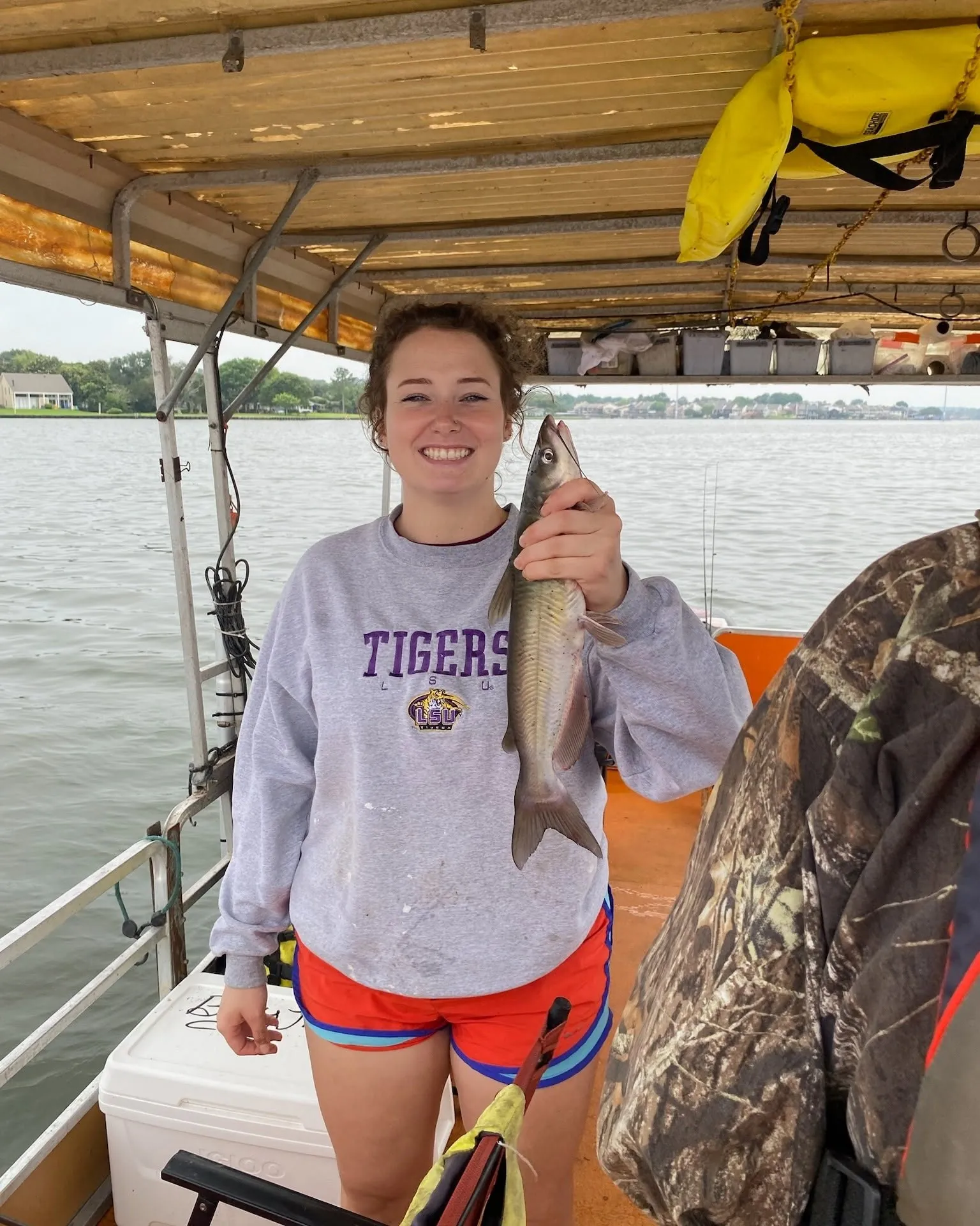 Guest holding a catfish on a Lake Conroe fishing boat. Lake Conroe Fishing Guide - Billy Mills