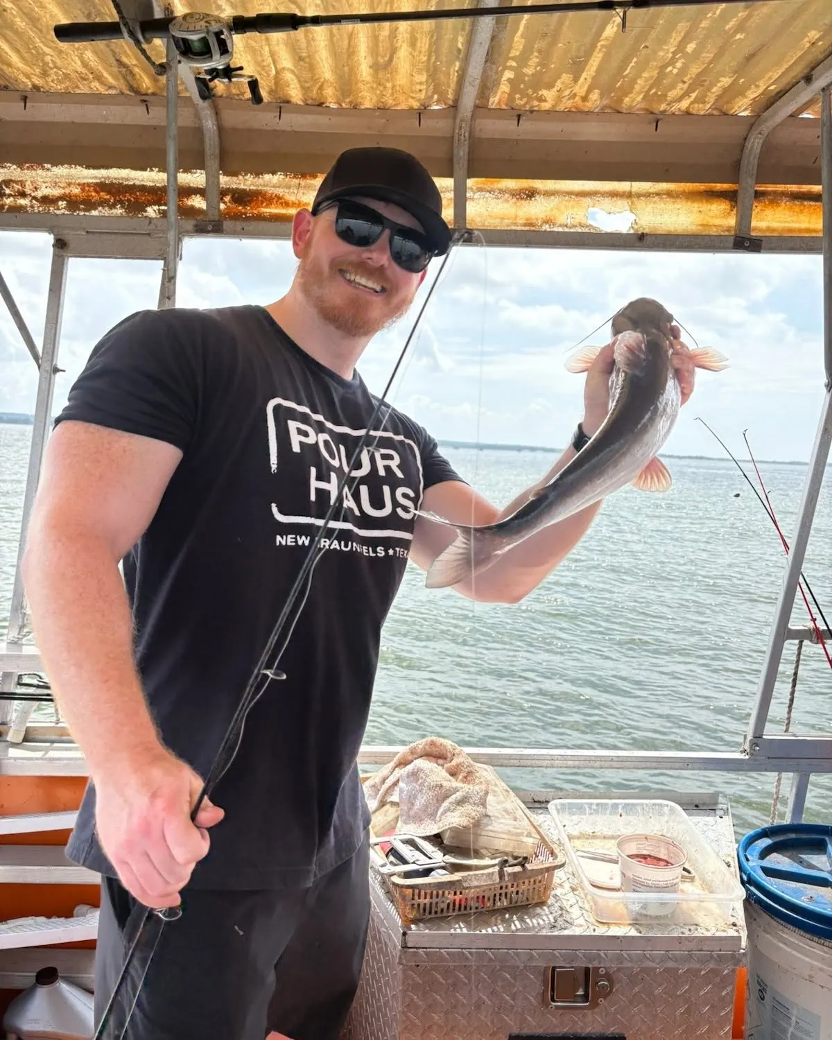 Smiling guest holding a fish on a Lake Conroe fishing boat. Lake Conroe Fishing Guide - Billy Mills