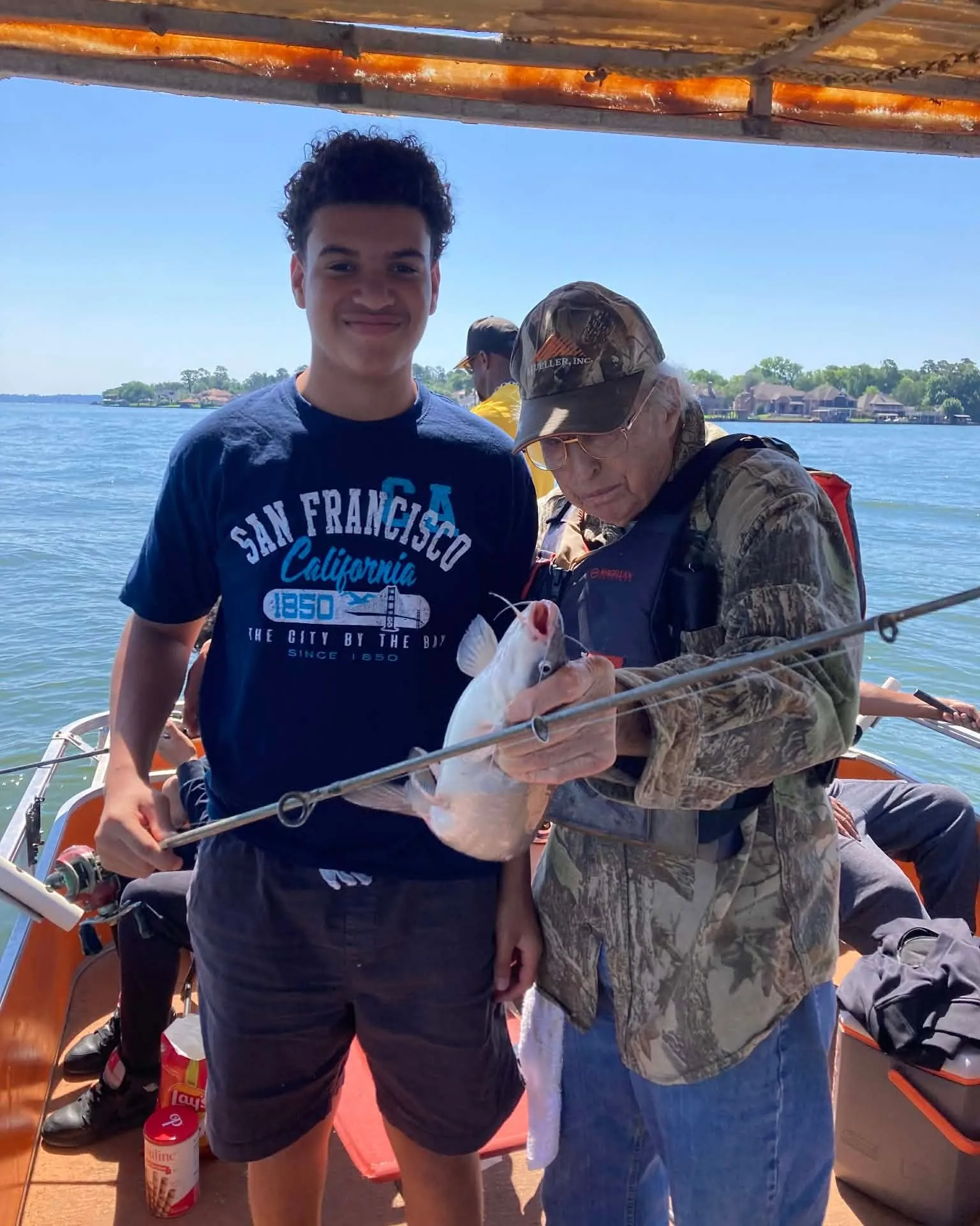 Teen angler holding a fishing rod on a Lake Conroe boat. Lake Conroe Fishing Guide - Billy Mills
