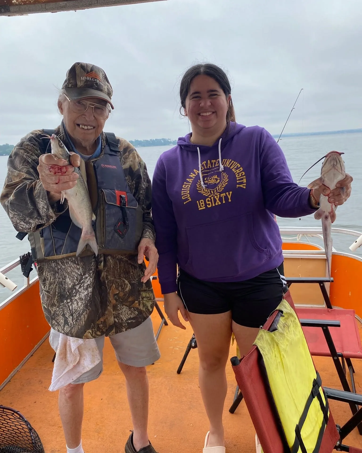 Two guests holding fish on a Lake Conroe fishing boat. Lake Conroe Fishing Guide - Billy Mills