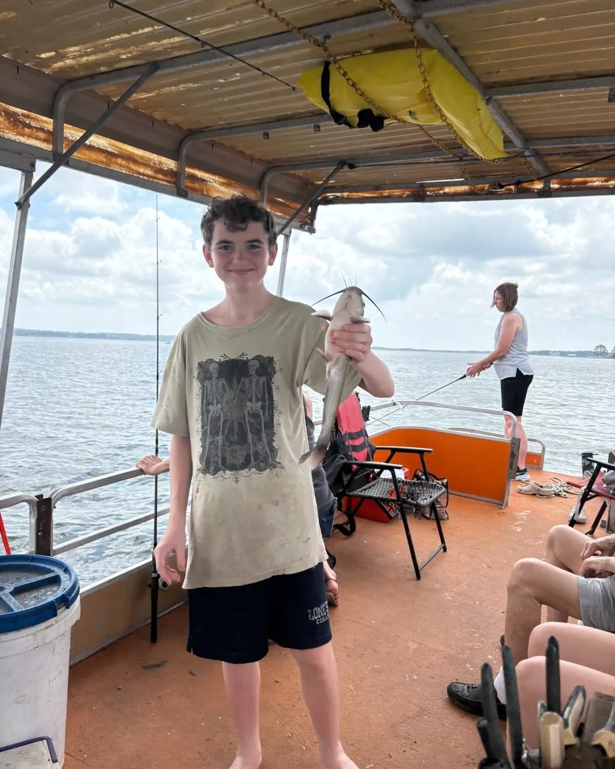 Young angler holding a catfish on a Lake Conroe boat. Lake Conroe Fishing Guide - Billy Mills