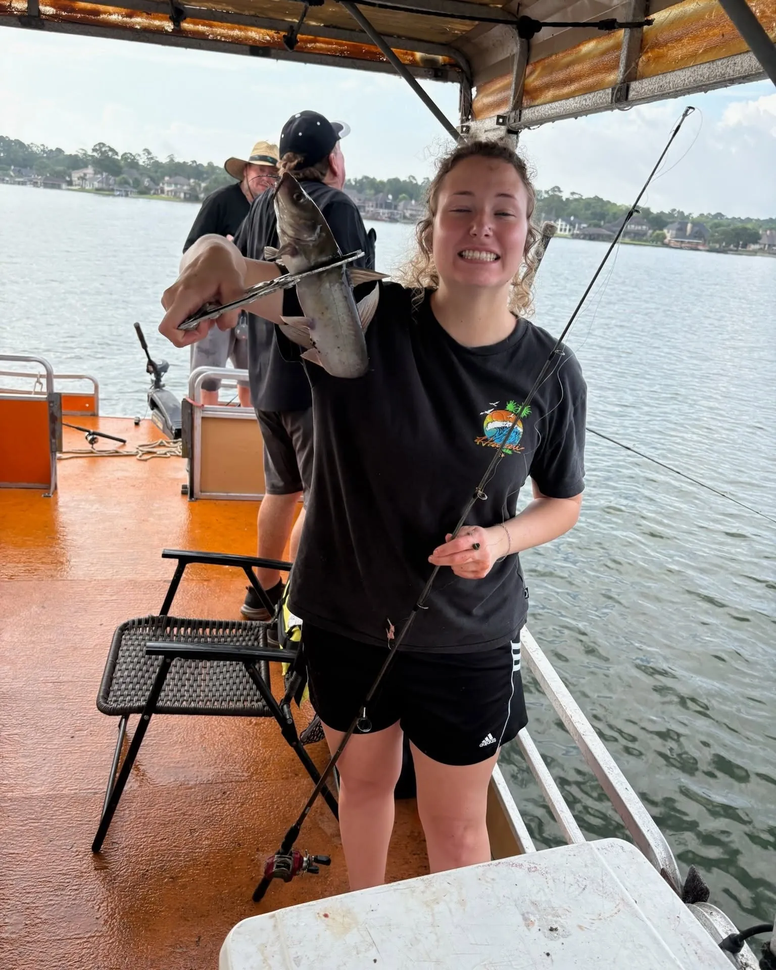 Young guest smiling from a covered fishing boat on Lake Conroe. Lake Conroe Fishing Guide - Billy Mills