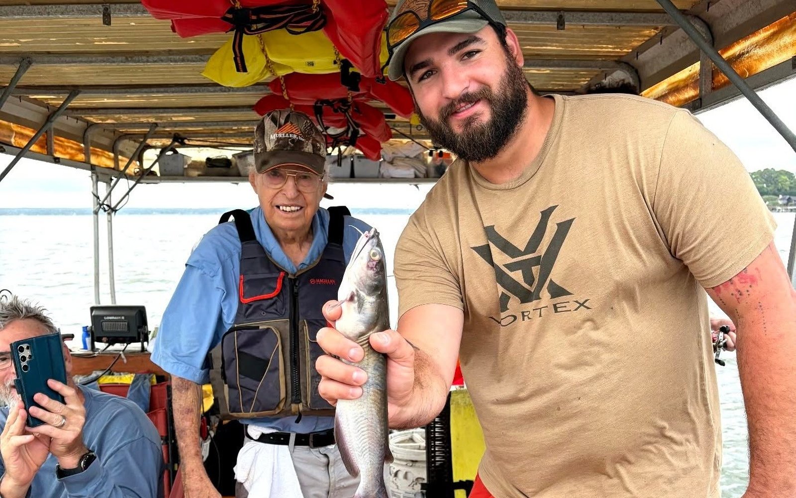 Guest showing a catfish with Billy Mills during a Lake Conroe fishing trip. Lake Conroe Fishing Guide - Billy Mills