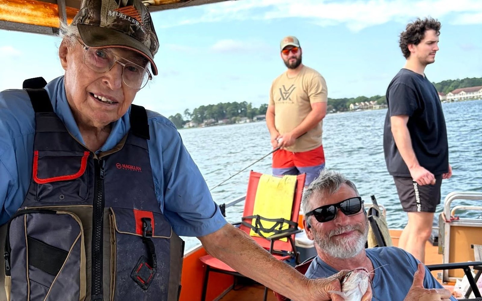Billy Mills with guests and a catfish during a Lake Conroe fishing trip. Lake Conroe Fishing Guide - Billy Mills