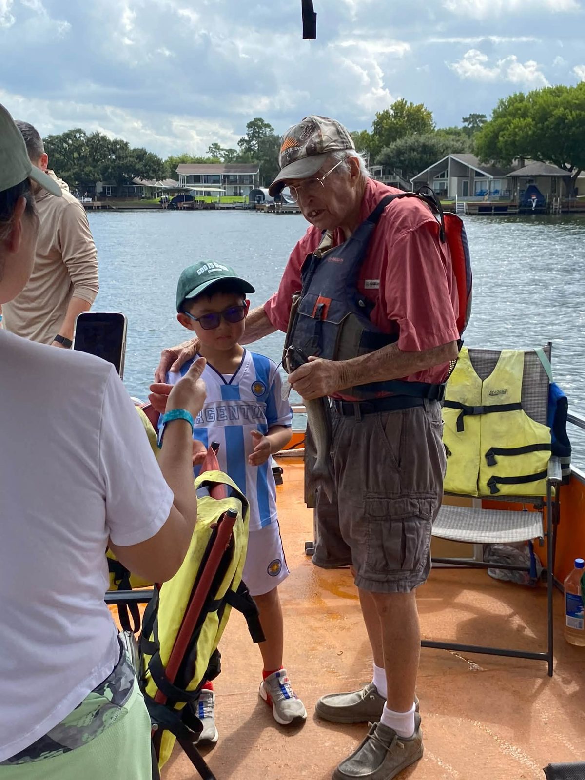 A young angler and Billy holding a fish on the boat