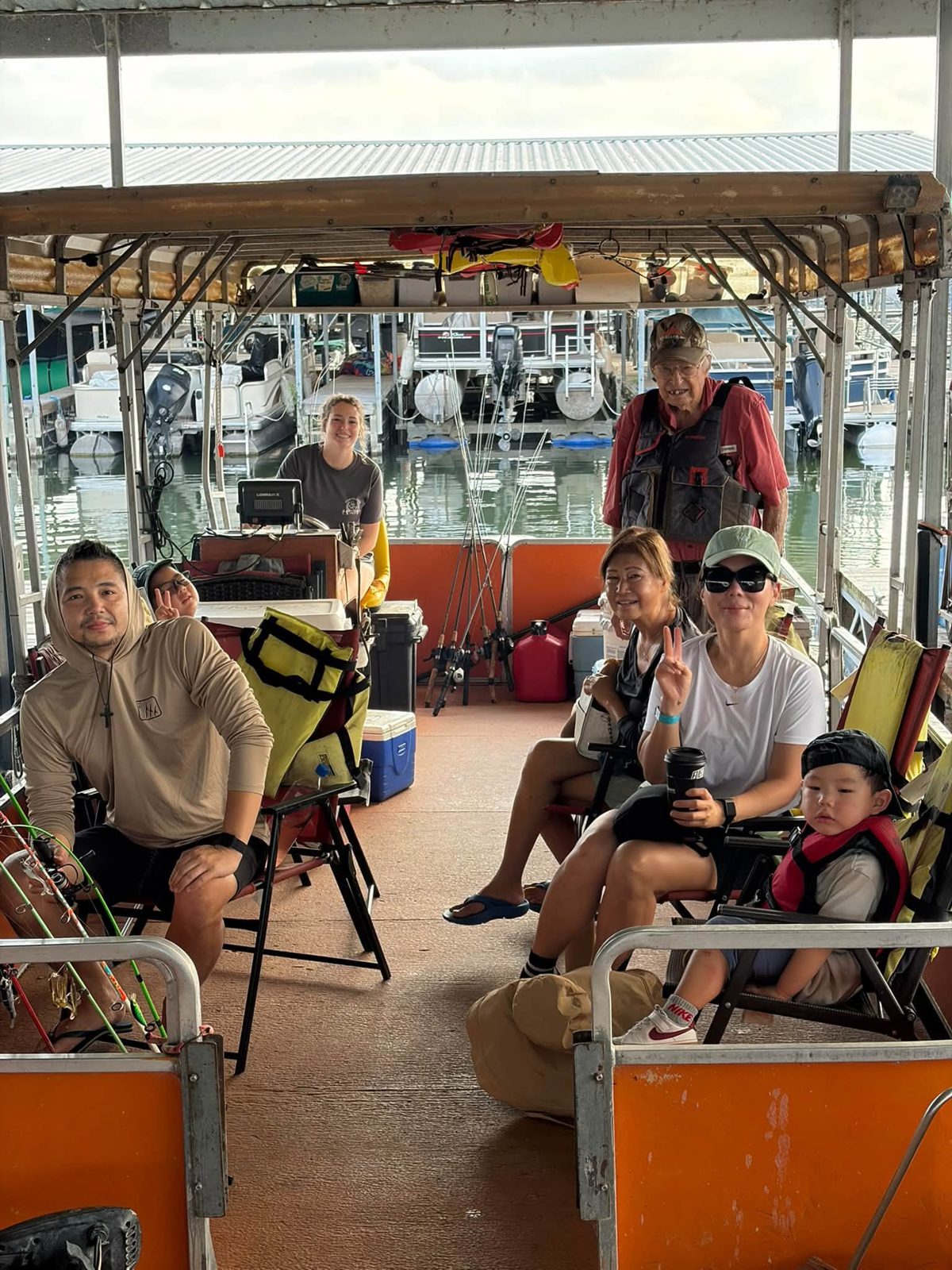 Family relaxing together under the boat canopy
