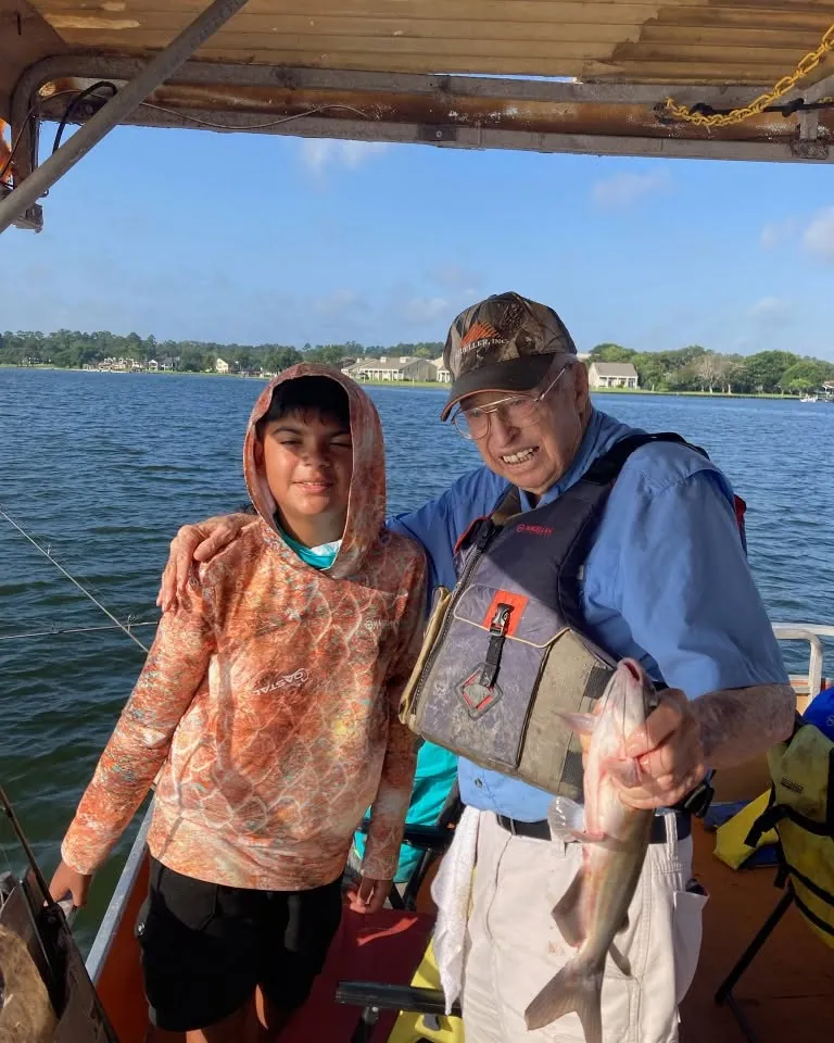 Billy standing with a young guest holding a fish. Lake Conroe Fishing Guide - Billy Mills