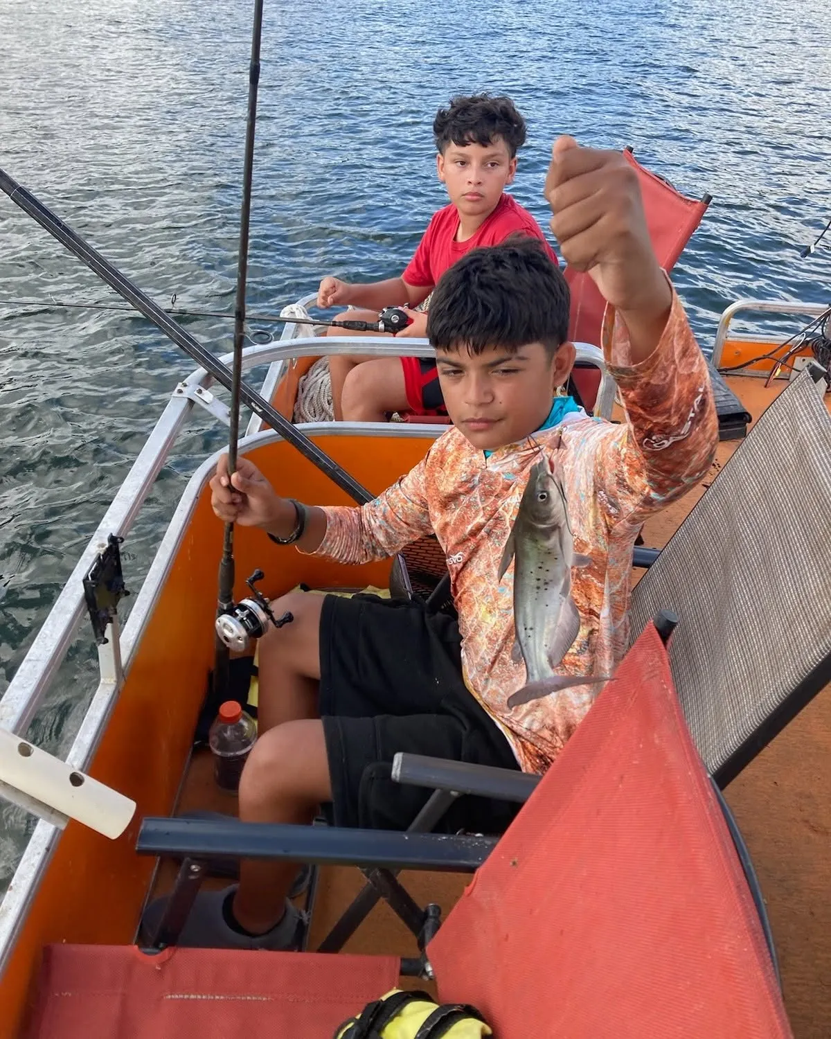 Young angler holding a catfish on a Lake Conroe boat. Lake Conroe Fishing Guide - Billy Mills