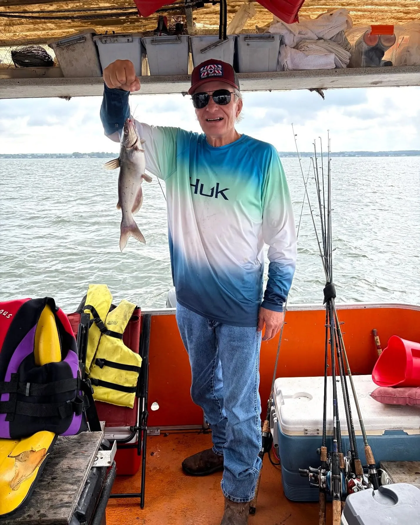 Billy Mills holding a catfish aboard his Lake Conroe fishing boat. Lake Conroe Fishing Guide - Billy Mills