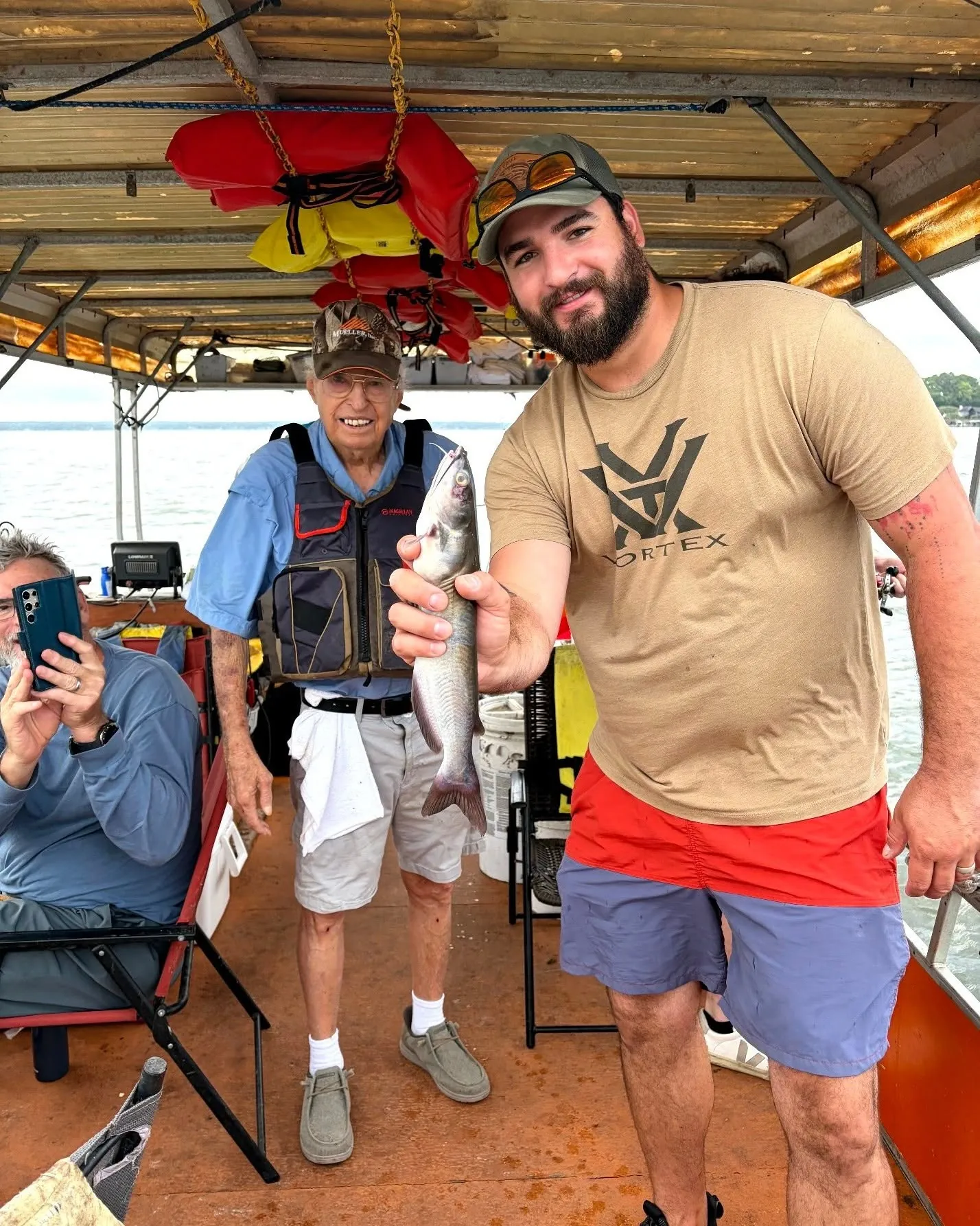 Guest holding a fish on Billy Mills' Lake Conroe fishing boat. Lake Conroe Fishing Guide - Billy Mills