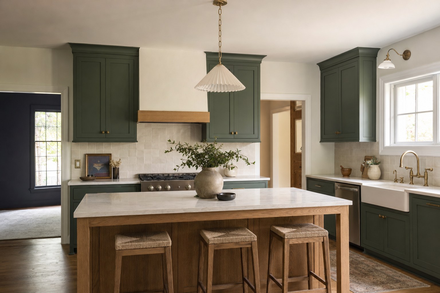 Remodeled kitchen with dark green cabinets and wood island