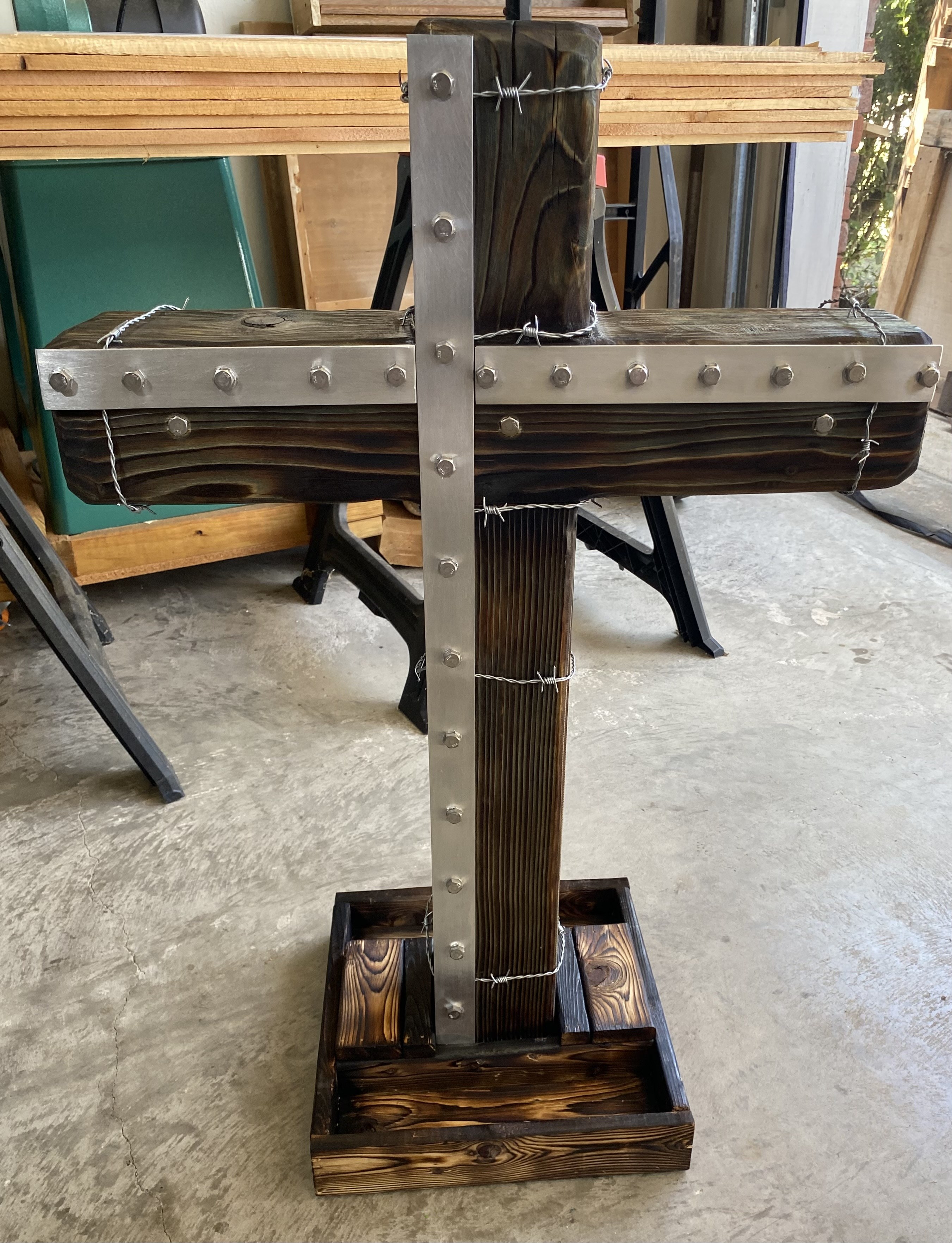 Handmade wooden cross with steel plates and bolts