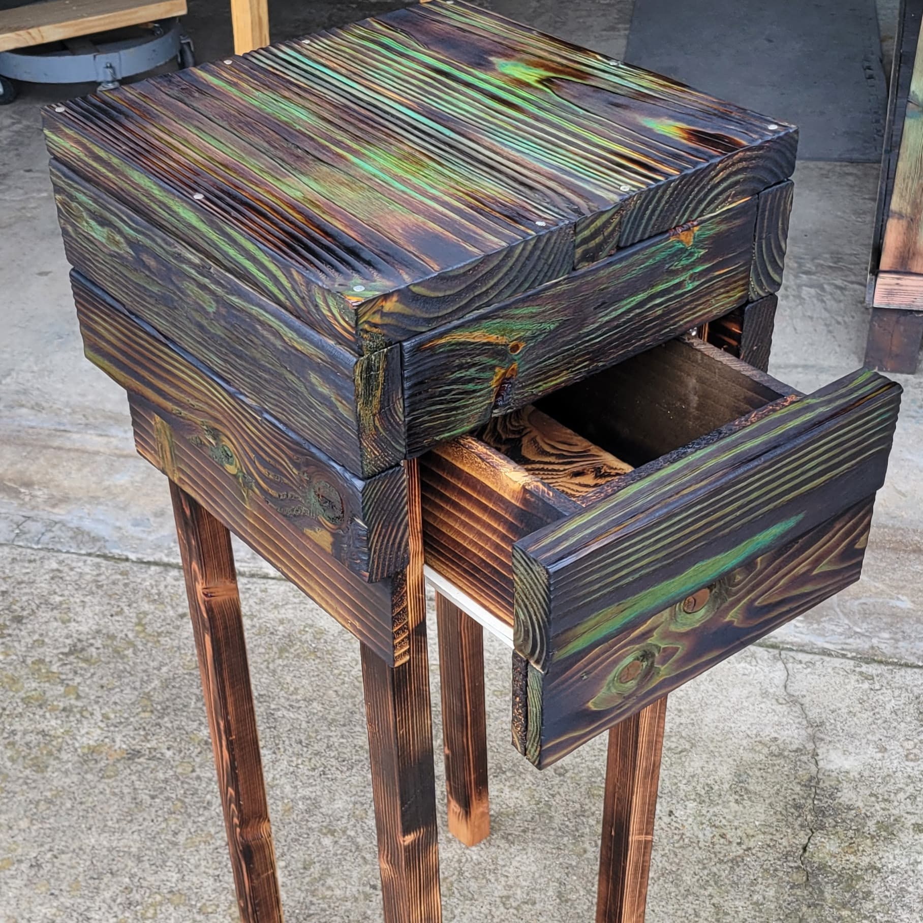 Handmade colorful wooden table with open drawer