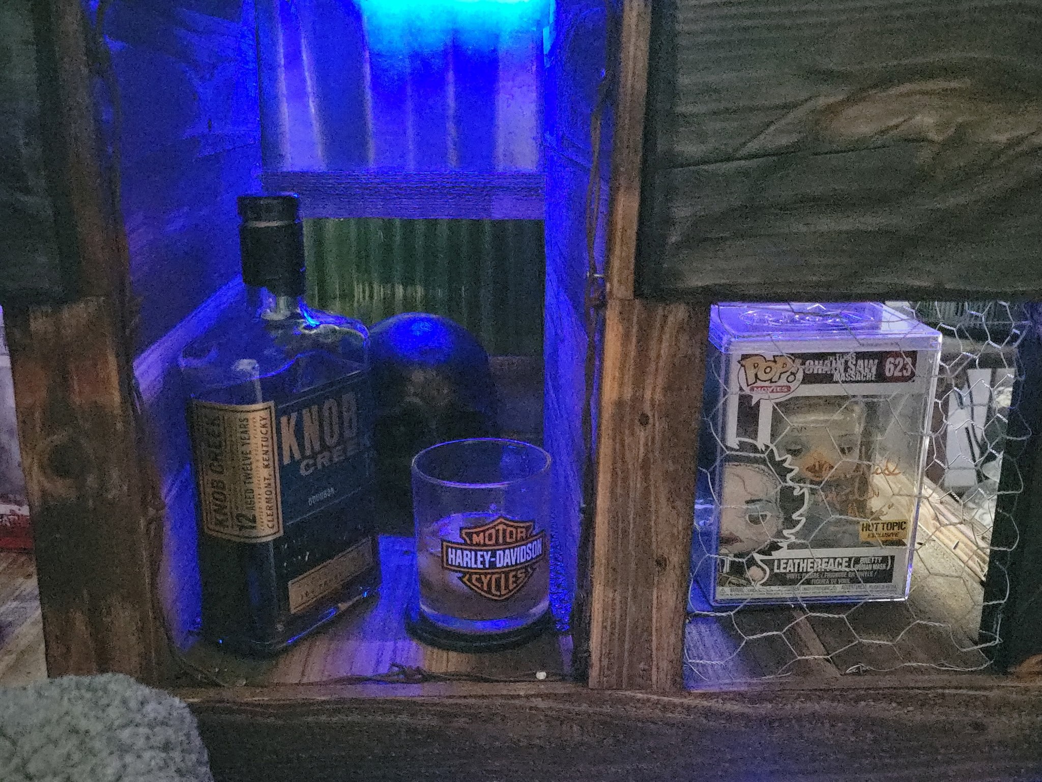 Blue-lit custom wood display cabinet detail