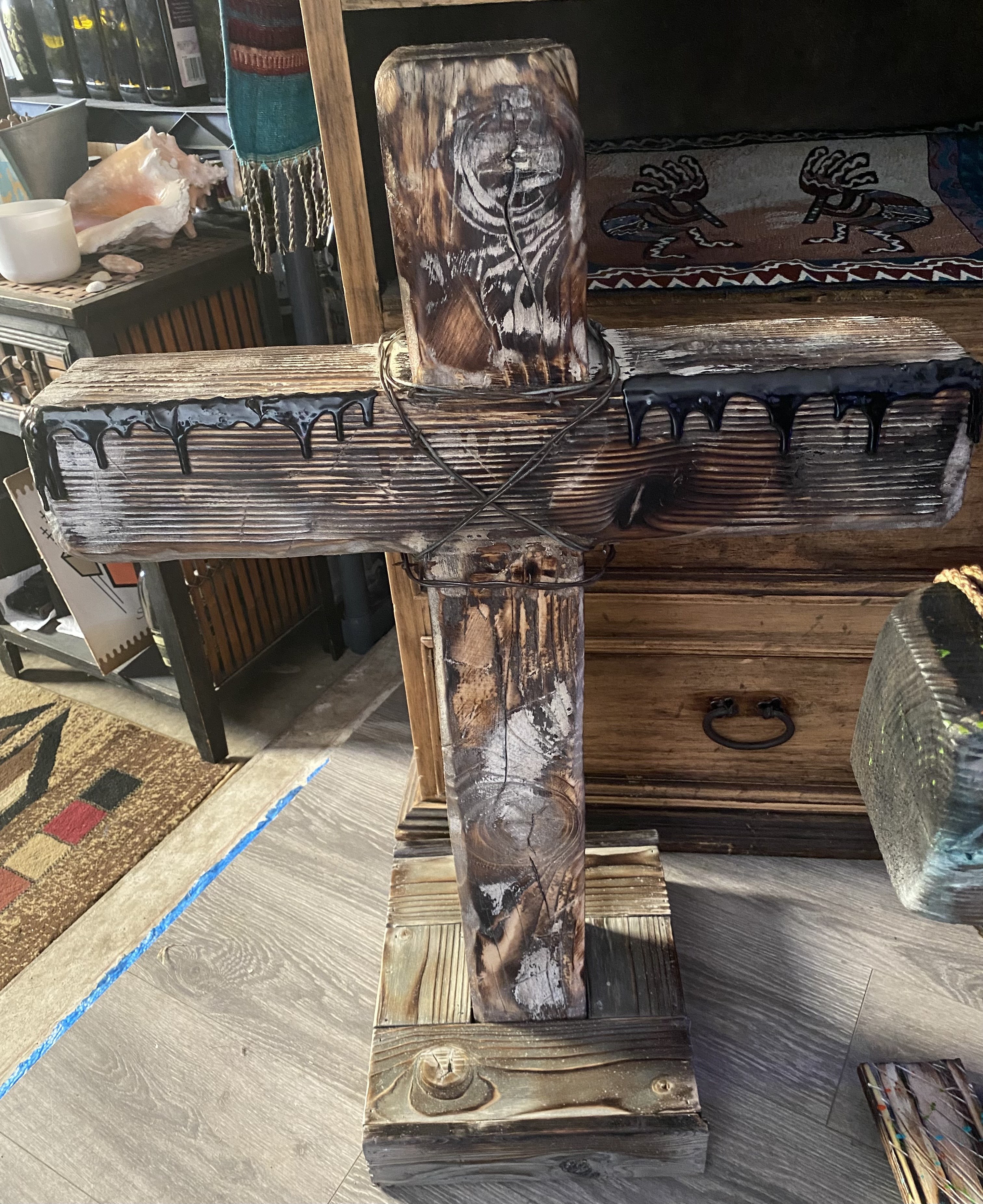Black handmade wooden cross with a raven detail
