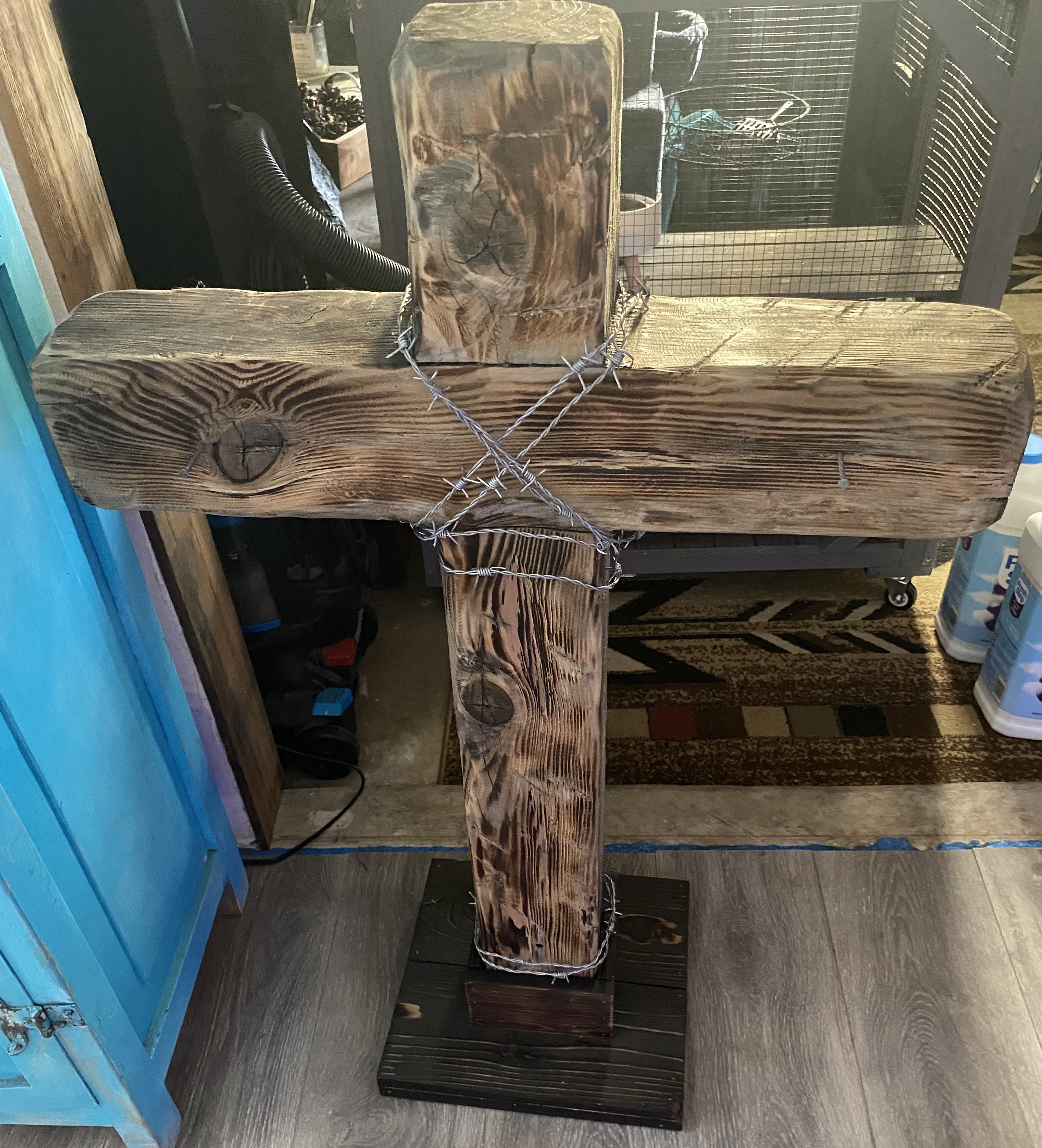 Natural-finish handmade wooden cross displayed outside