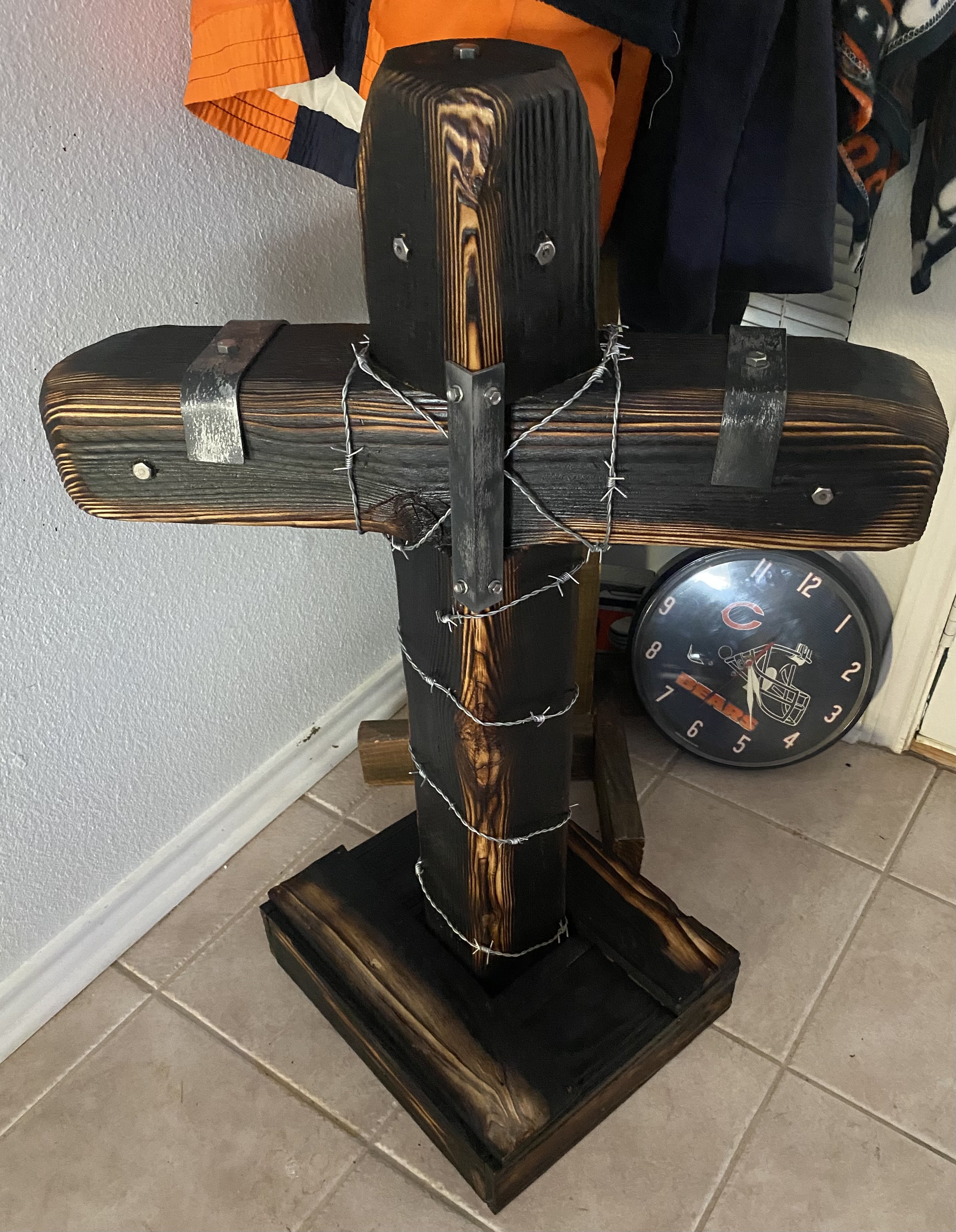 Blackened handmade wooden cross with steel plates and barbed wire detail