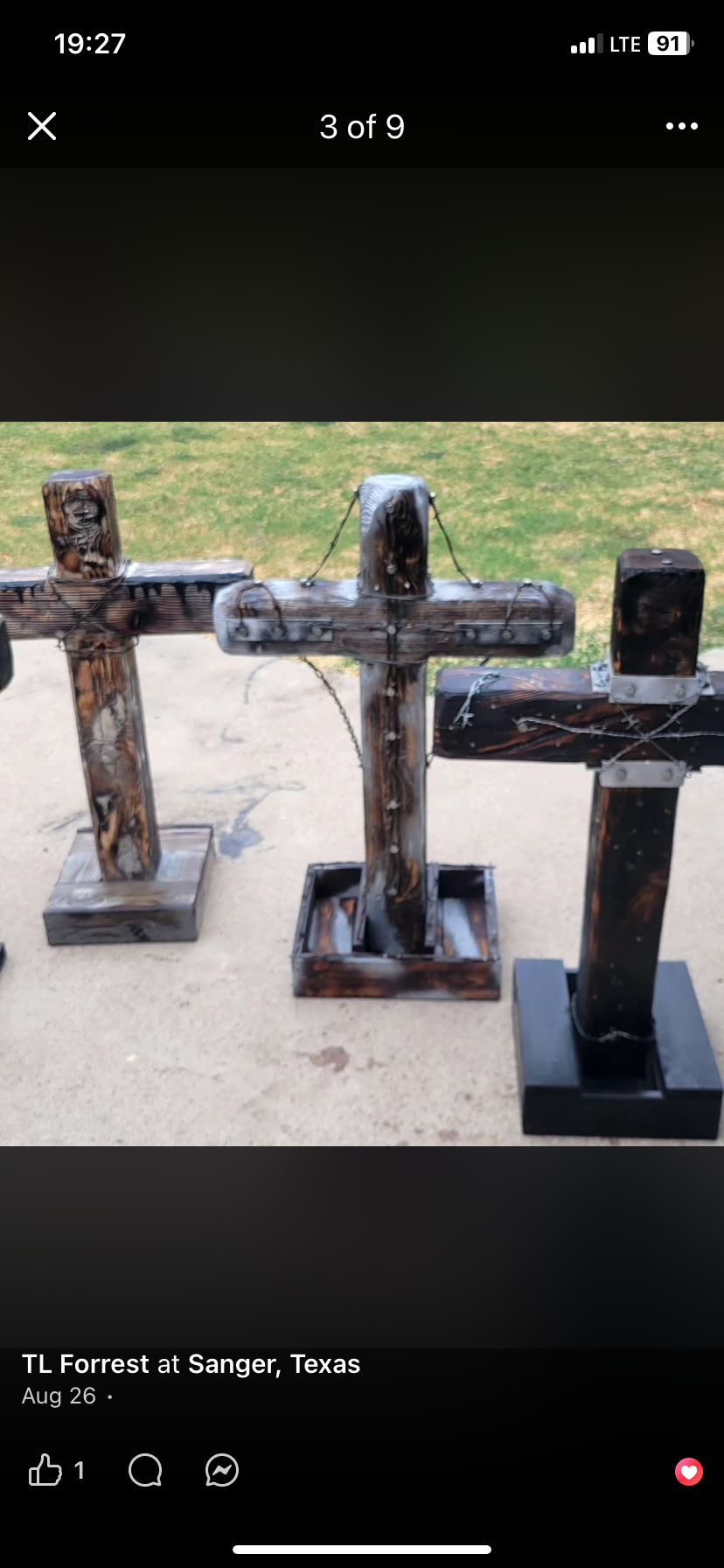 Three handmade wooden crosses displayed outside