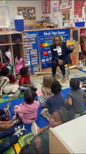 Children and an adult sharing circle time