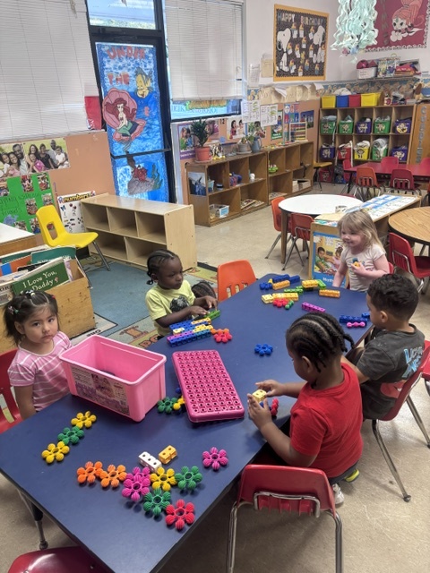 Children playing with colorful blocks in the Peek-A-Boo classroom