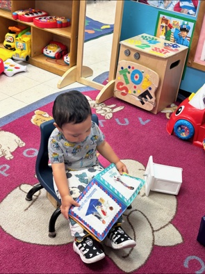 A young child exploring a picture book