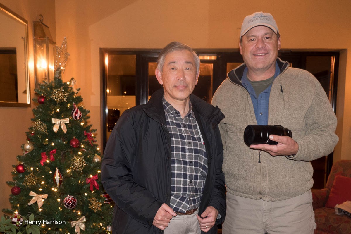 Panasonic Chief engineer Takanori Yabuki hands Daniel Cox the new 100-400mm zoom lens Panasonic developed for a shoot in Bosque Del Apache, New Mexico.