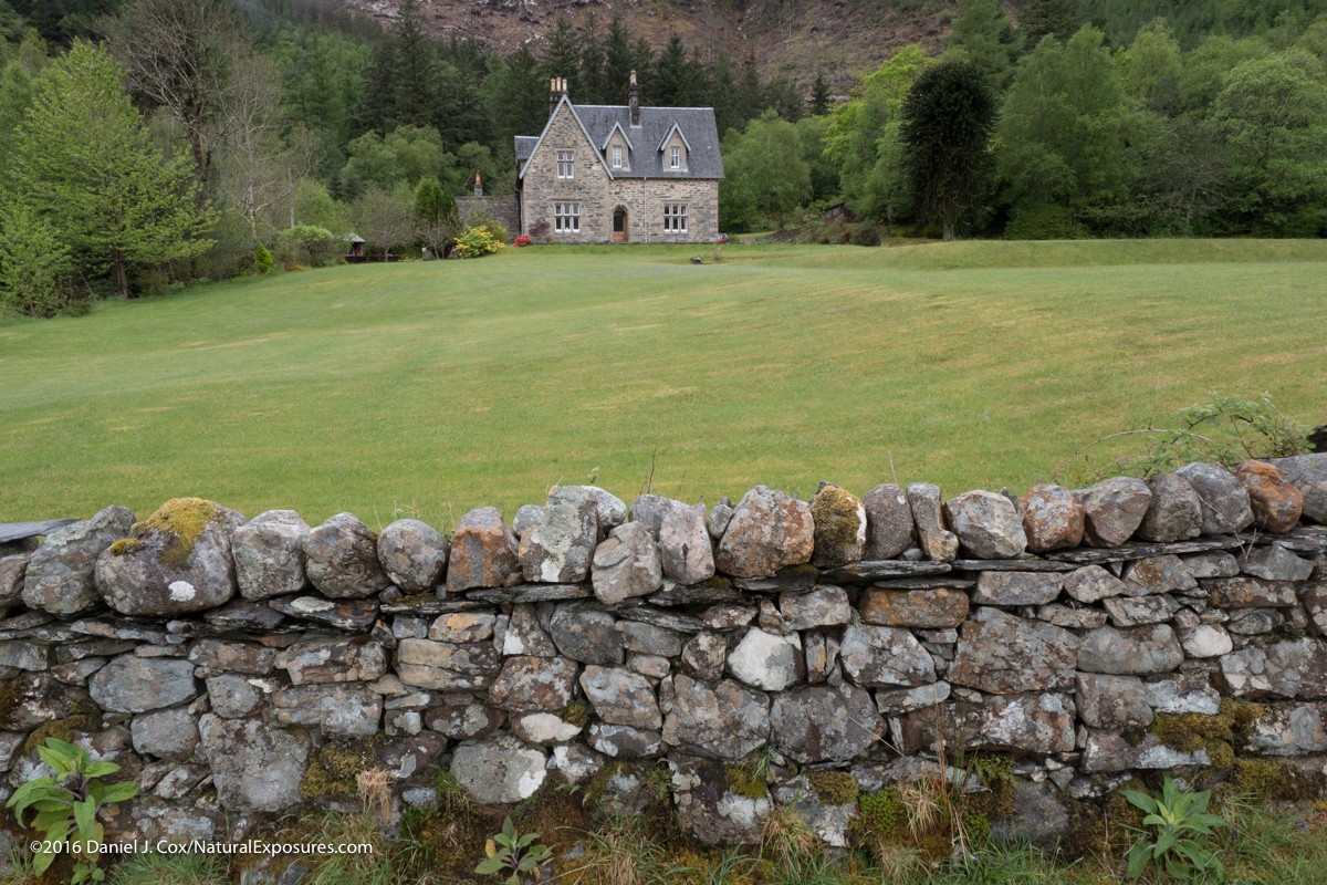 Beautiful depth of field from front to back shows the rock wall surrounding this beautiful home on the Isle of Skye in Scotland. GX8 ISO 200
