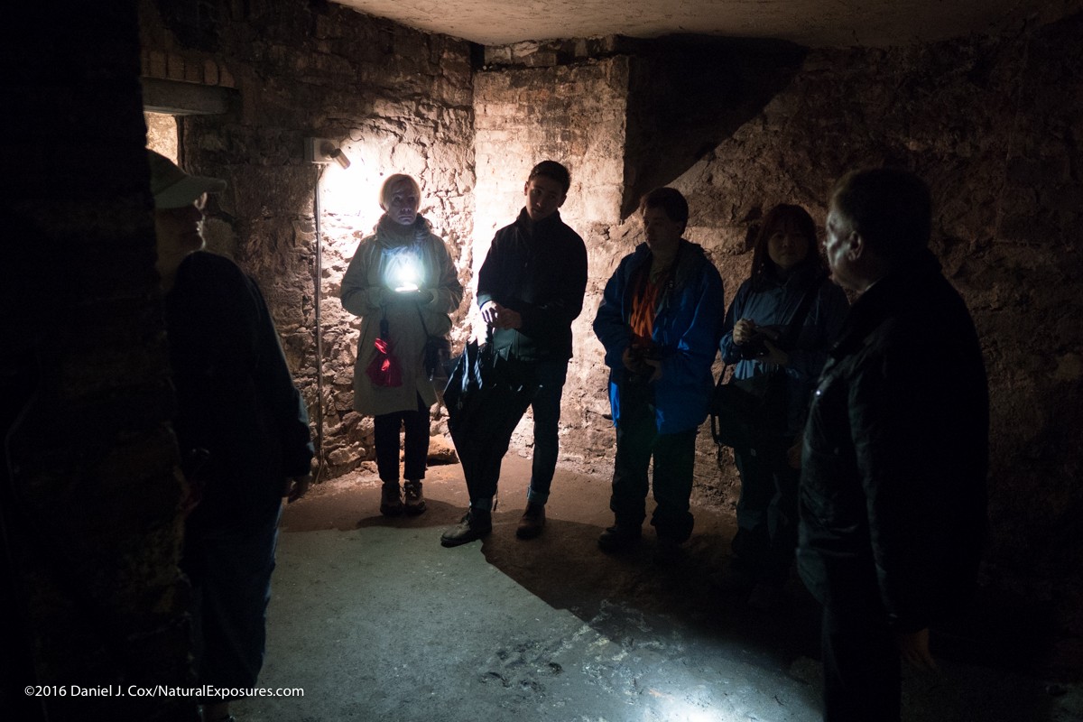 Our Explorers on a tour of the underground tunnels in Edinburgh. Typically a bright light like the flashlight in this photo would create flair in a lens that has issues. but as you see there is no problem in this situation. GX8 ISO 3200