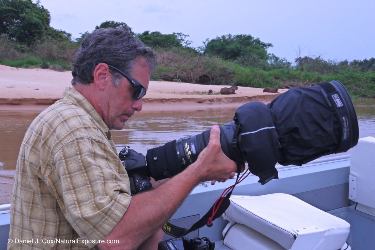 Now that's a lens. In this photo I'm working with the amazing nikkor 600mm F/4 on a river in the Pantanal of Brazil. That lens in my hands is just over ten pounds and cost almost $12,000.00US when I bought it. 