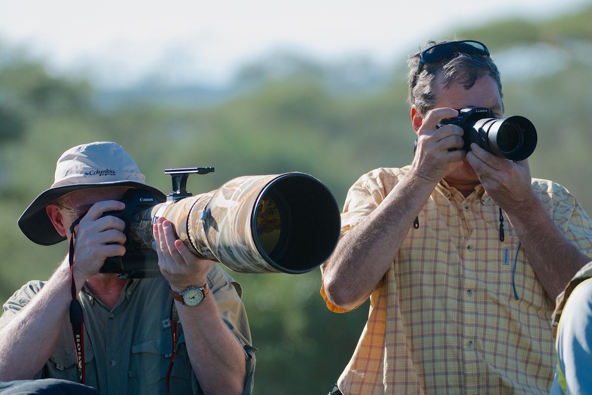 A comparison shot that shows the size difference between a normal sized Canon 600mm F/4 telephoto and the similarly powerful Panasonic GH3 with a 100-300mm lens that converts to a 200-600mm F/4-5.6 equivalent zoom. Just in case you can't see the GH3, it's on the right and the Canon is on the left.