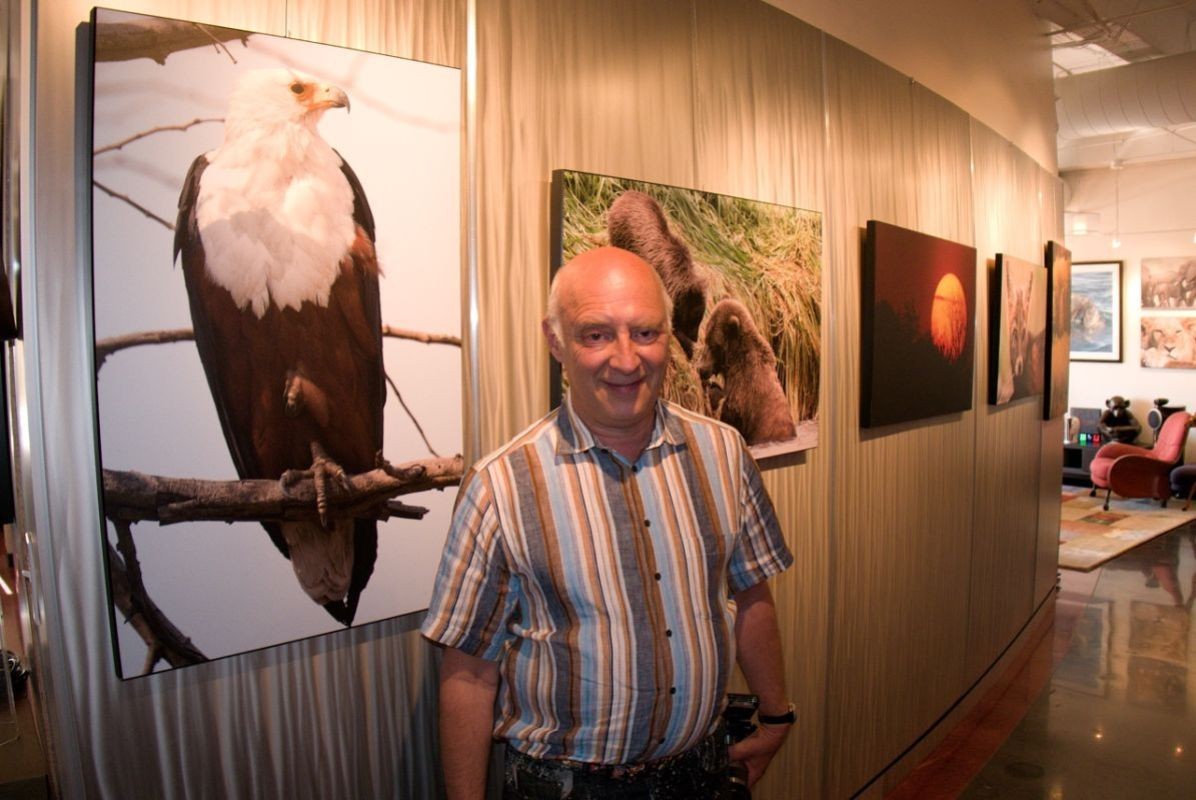 David Vaskevitch, CEO of Mylio in front of a wall of his photography at Mylio headquarters in Seattle, Washington.