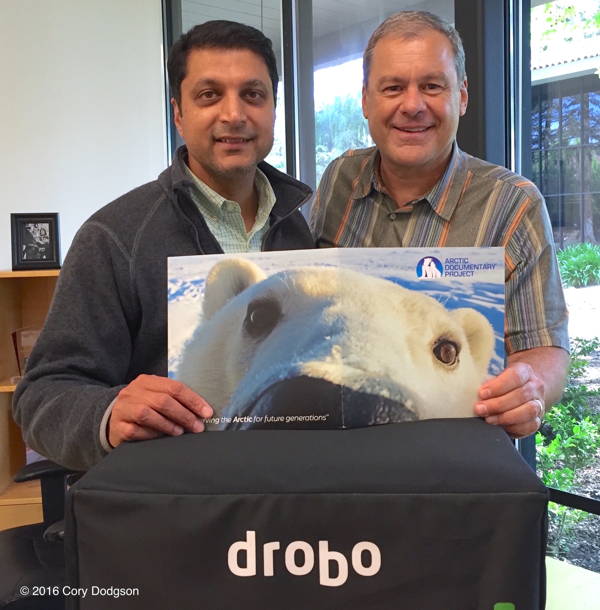 Mihir Shaw and Daniel Cox holding a copy of the Arctic Documentary Project brochure. One of the projects Drobo is indirectly supporting through the donation of a Drobo 5D to hold that Dan's photos are archived on. 