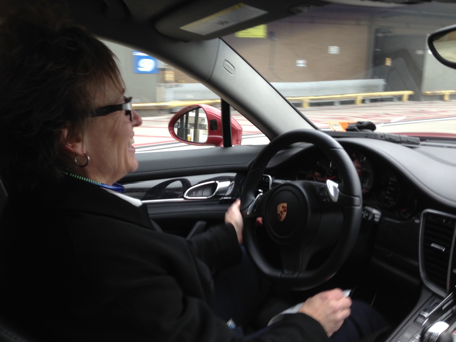 Delta employee extraordinaire Deborah Pratt behind the wheel of a fabulously gorgeous Porsche driving me to my gate so I don't miss my flight to Bozeman.