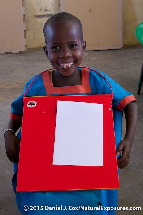 A young Samburu village boy tests out the new Outpostz Lap Desk. Kenya