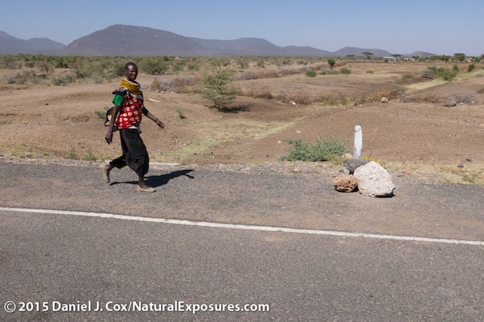 A lady walks the new highway built within the last four years outside of Isiolo, a small town that is scheduled to become a gambling town somewhat like Las Vega. Lumix LX100
