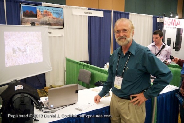 Barry Walton at his booth showing off his new ultra portable projection screen.