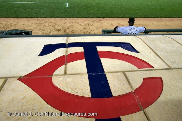 No idea who this player is or maybe he was a coach. I just liked the composition with the Twins logo on the dugout in front. Lumix GM1 with 12-35mm lens. ISO 640