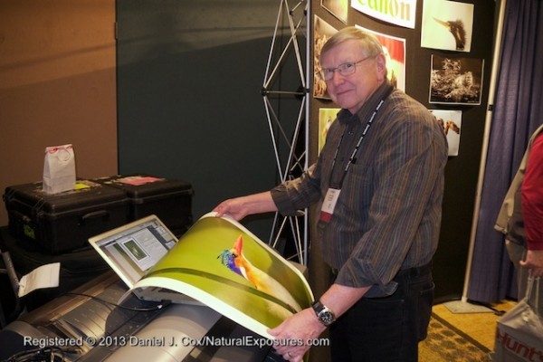 George Lepp checks a print from a Canon large format printer at the Canon booth.