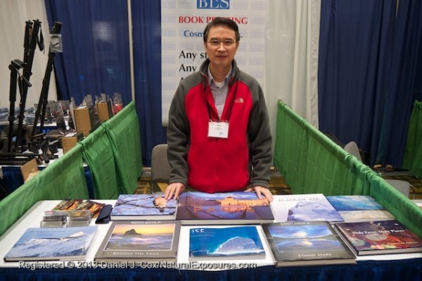 Sam Sheng shows off his products of large format photos books at the NANPA conference in Jacksonville, Florida, 
