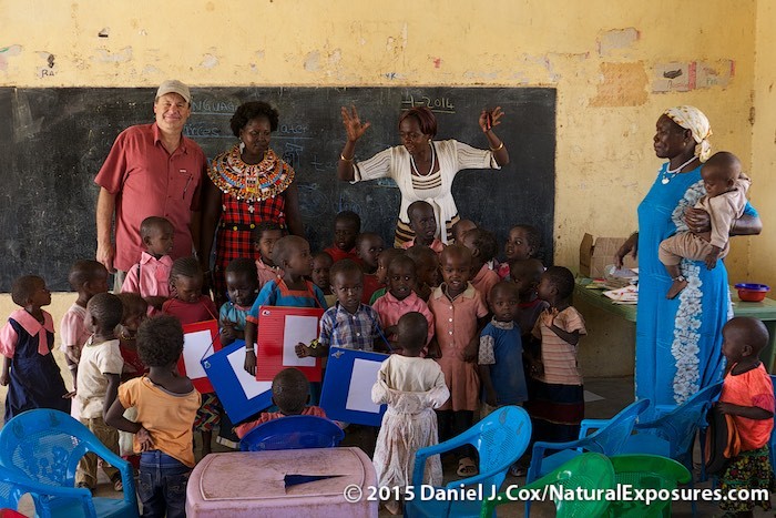 I get in on a shot with the teachers and the kids. "Hey you guys, your'e supposed to be looking at the camera". The broken desk I mention in the text is in the foreground. Kenya