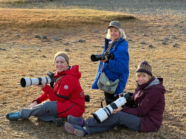 Three NE Explorers with telephoto cameras outdoors